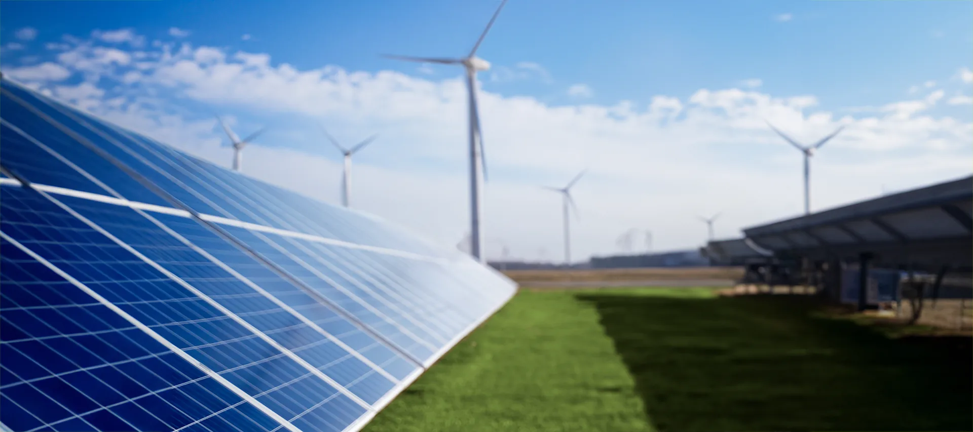 Solar panels and wind turbines at a renewable energy site