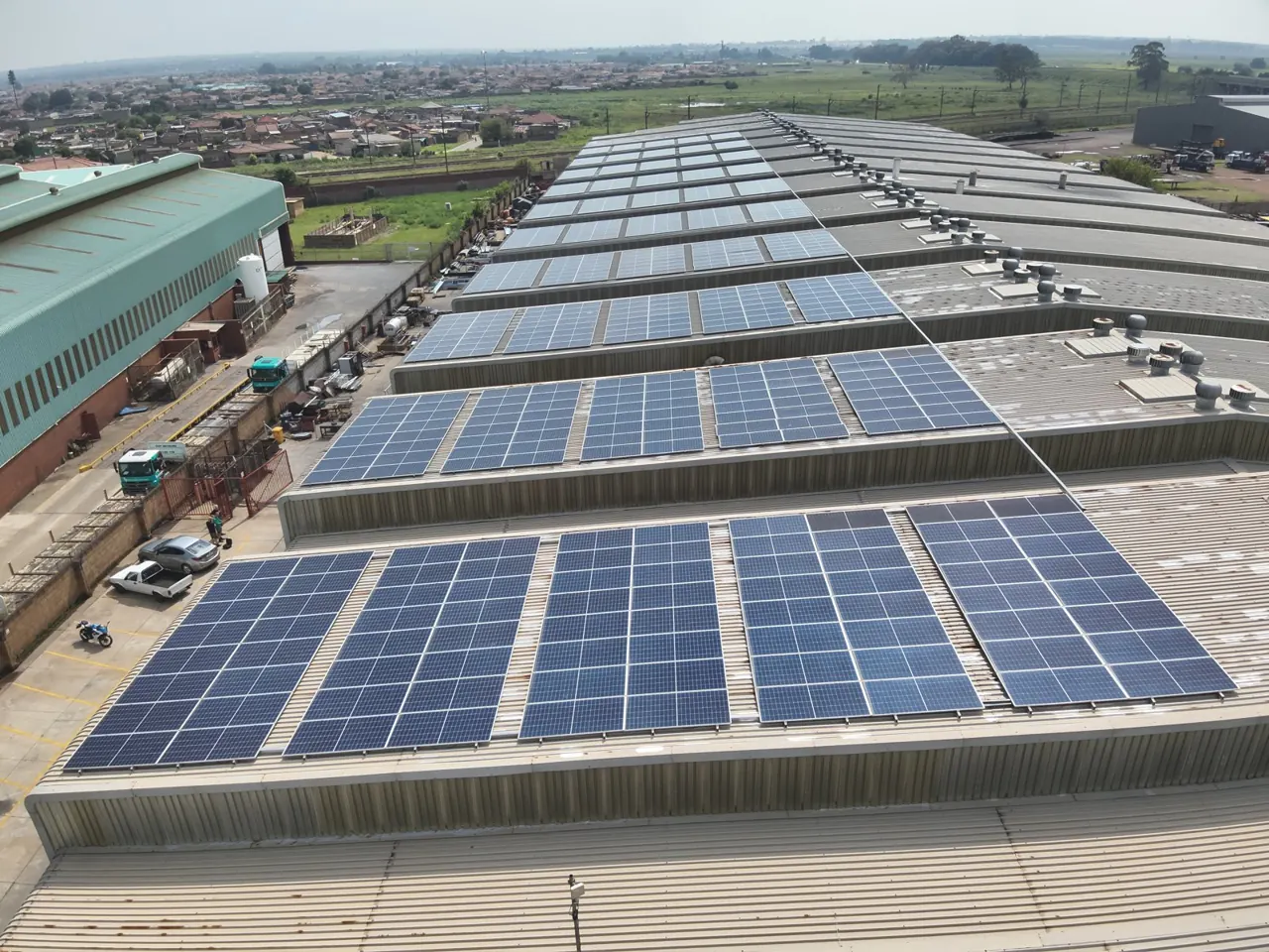 Rows of rooftop solar panels across a warehouse roof in Germiston, Gauteng